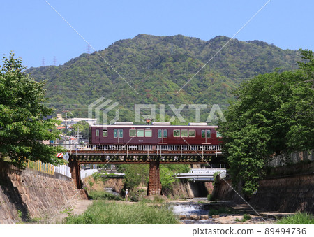 Hankyu Kobe Line 7000 series train crossing the Toga River Hankyu Kobe Line 7000 series train crossing the Toga River 89494736
