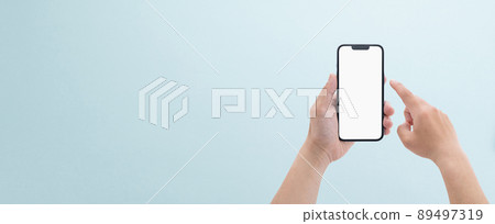 Banner size at hand of a man with a smartphone 89497319