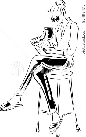A woman reading a newspaper while drinking coffee at a cafe 89498479