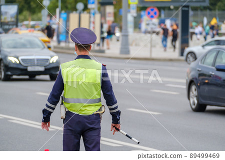 Traffic officer standing near road 89499469