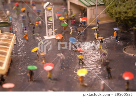 People walking around the city with an umbrella 89500585