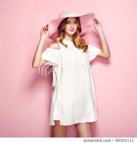 Blonde young woman in summer white dress 89503111