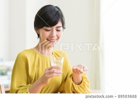 Women taking medicine Supplements Health 89503688