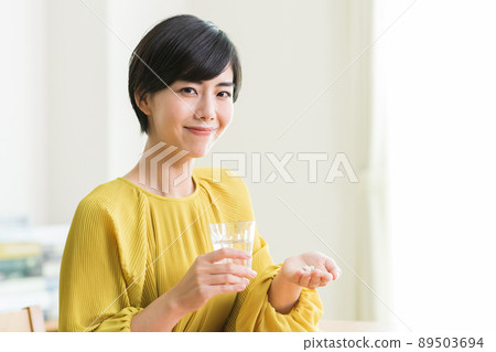 Women taking medicine Supplements Health 89503694