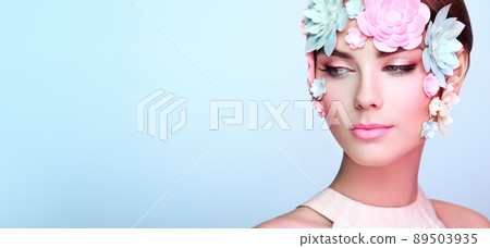 Face of beautiful woman decorated with flowers Face of beautiful woman decorated with flowers 89503935