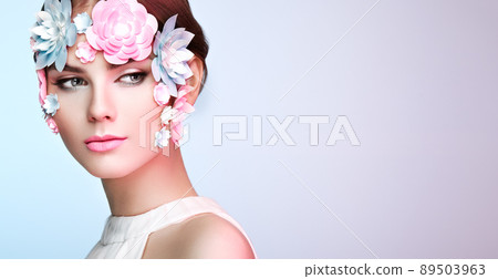 Face of beautiful woman decorated with flowers Face of beautiful woman decorated with flowers 89503963