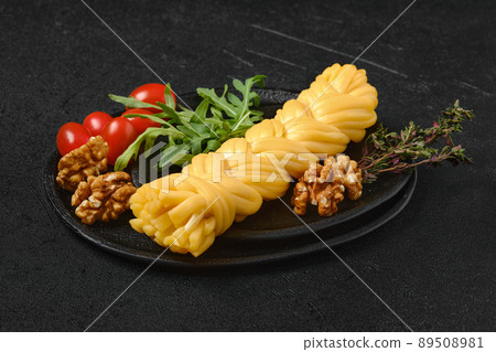 Smoked braided cheese on a plate 89508981