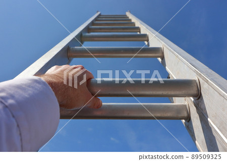 Hands climbing a ladder to the sky 89509325