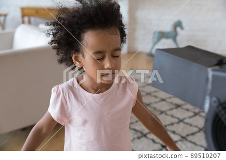 Calm African American little kid girl standing at cool air 89510207