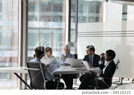 Serious adult female business leader instructing diverse team Serious adult female business leader instructing diverse team 89510225