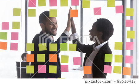 Happy business teacher woman and intern guy giving high five 89510412