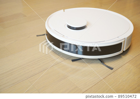 Image photo of a white cleaning robot cleaning the living room Image photo of a white cleaning robot cleaning the living room 89510472