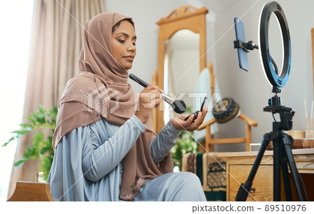 Make-up tips for this years Eid celebrations. Shot of a young muslim female busy recording her for her vlog. 89510976