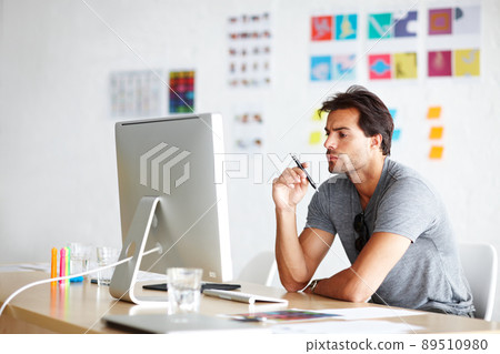 Thinking of ideas for his project. A handsome young man looking bored in front of his computer. Thinking of ideas for his project. A handsome young man looking bored in front of his computer. 89510980