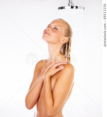 This water pressure is perfect. Cute young woman loving the water on her head as she has a shower - Copyspace. 89511158