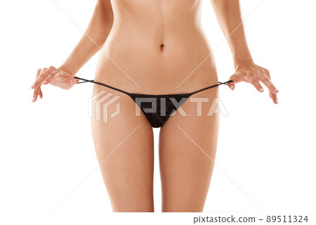 Beautiful in the bare minimum. Cropped shot of a woman pulling at her revealing thong. Beautiful in the bare minimum. Cropped shot of a woman pulling at her revealing thong. 89511324