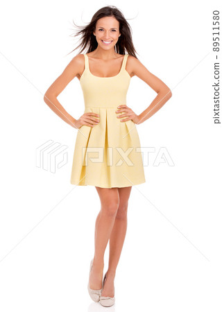 Ready to show summer a good time. Full-length studio portrait of a beautiful young woman posing in a yellow dress. Ready to show summer a good time. Full-length studio portrait of a beautiful young woman posing in a yellow dress. 89511580