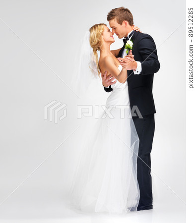 Enjoying their first dance. Portrait of a cute newlywed couple embracing. 89512285