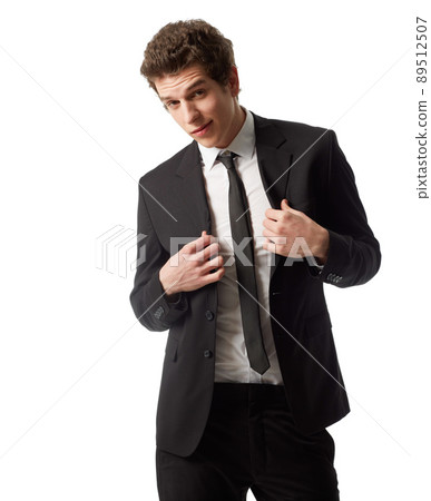 Suit up. A young man wearing a suit and tie standing in front of a white background. Suit up. A young man wearing a suit and tie standing in front of a white background. 89512507