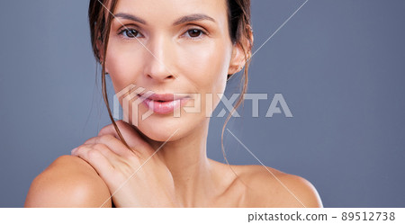 Feeling comfortable in my skin. Shot of a young woman admiring her skin against a studio background. 89512738
