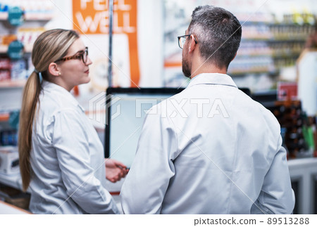 Theyve got your back for all your medical needs. Rearview shot of two pharmacists working in a pharmacy. Theyve got your back for all your medical needs. Rearview shot of two pharmacists working in a pharmacy. 89513288