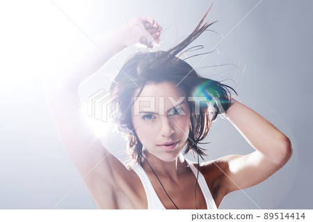 Let the music set you free. Cropped portrait of an attractive young woman dancing with total freedom. 89514414