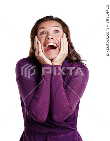 I cant believe it. A beautiful young woman with her hands on her face in excitement. 89514415