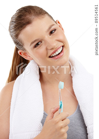 Sparkly white teeth and a radiant smile. A pretty teenage girl holding a toothbrush and smiling. Sparkly white teeth and a radiant smile. A pretty teenage girl holding a toothbrush and smiling. 89514561