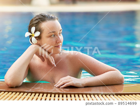 Its always cool by the pool. Shot of a young woman relaxing in the pool at a spa. Its always cool by the pool. Shot of a young woman relaxing in the pool at a spa. 89514699