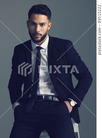 The man knows how to dress. Studio shot of a young man posing against a grey background. 89515222