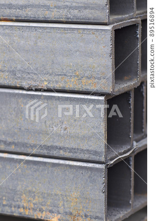 Metal profile pipe of rectangular cross section in packs at the warehouse of metal products Metal profile pipe of rectangular cross section in packs at the warehouse of metal products 89516894