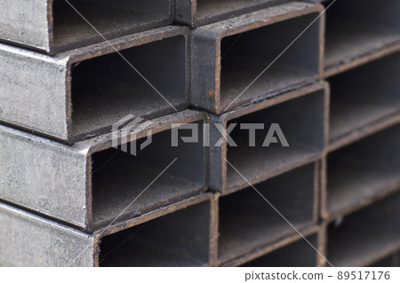 Metal profile pipe of rectangular cross section in packs at the warehouse of metal products Metal profile pipe of rectangular cross section in packs at the warehouse of metal products 89517176