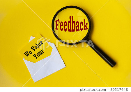 Top view of text - we value your feedback on notepad and magnifying glass. Conceptual Top view of text - we value your feedback on notepad and magnifying glass. Conceptual 89517448