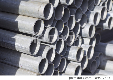Metal profile pipe of round section in packs at the warehouse of metal products Metal profile pipe of round section in packs at the warehouse of metal products 89517683