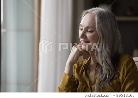 Happy dreamy beautiful mature lady looking away Happy dreamy beautiful mature lady looking away 89518163