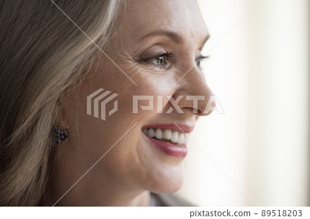 Happy dreamy mature grey haired lady face with makeup Happy dreamy mature grey haired lady face with makeup 89518203