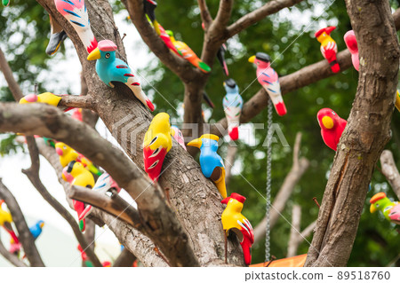 Artificial colorful birds decorated on tree Artificial colorful birds decorated on tree 89518760