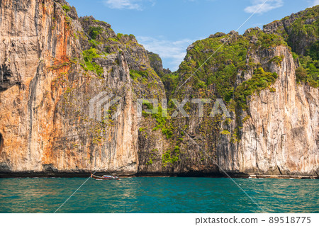 Tourist boat sail near karst mountain around Phi Phi island Tourist boat sail near karst mountain around Phi Phi island 89518775