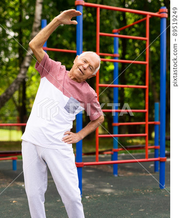 Senior man doing warming up exercises Senior man doing warming up exercises 89519249