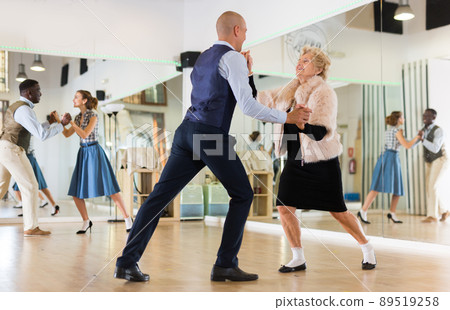 Mature woman dancing swing with young man 89519258