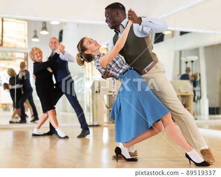 Woman and man dancing waltz in studio Woman and man dancing waltz in studio 89519337
