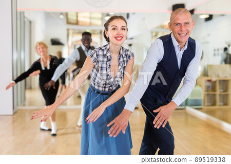Adult dancing couple enjoying active swing Adult dancing couple enjoying active swing 89519338