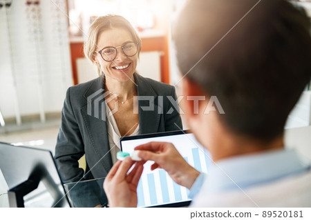 Male optometrist hands giving pair of contact lens in case to patient offering choice 89520181