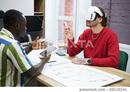 People using VR goggles at work People using VR goggles at work 89520241