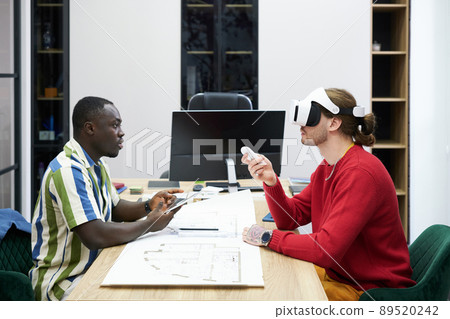 Colleagues using VR goggles at work Colleagues using VR goggles at work 89520242