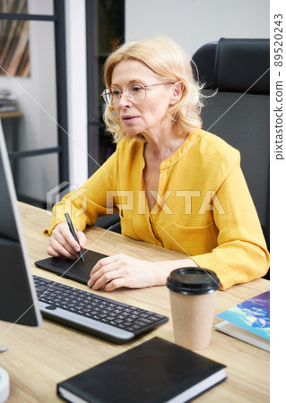 Woman working with graphic tablet Woman working with graphic tablet 89520243