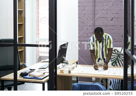 Construction engineer drawing blueprint at office Construction engineer drawing blueprint at office 89520255