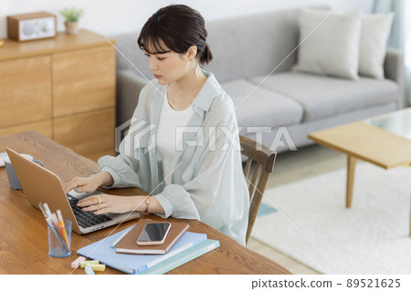 Young woman working remotely Young woman working remotely 89521625