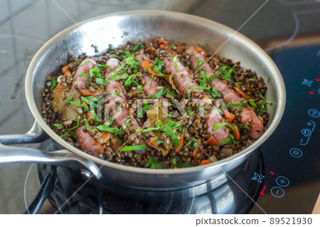 Chipolata sausages cooked with lentils, carrots and parsley Chipolata sausages cooked with lentils, carrots and parsley 89521930