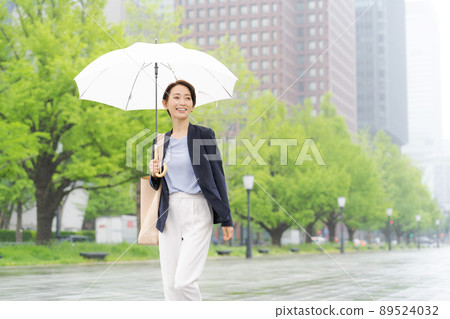 Women walking with an umbrella business 89524032